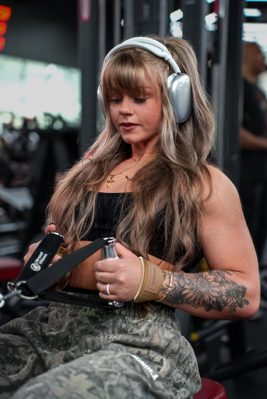 woman doing rowing exercises with uppper lifting straps