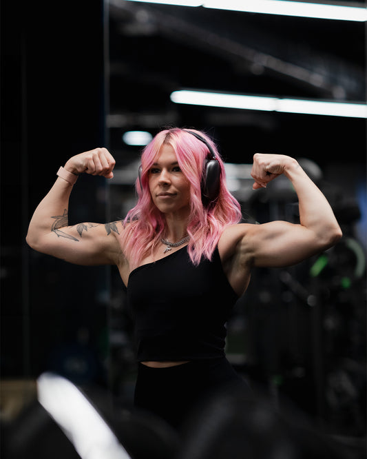 woman flexing in front of a mirror