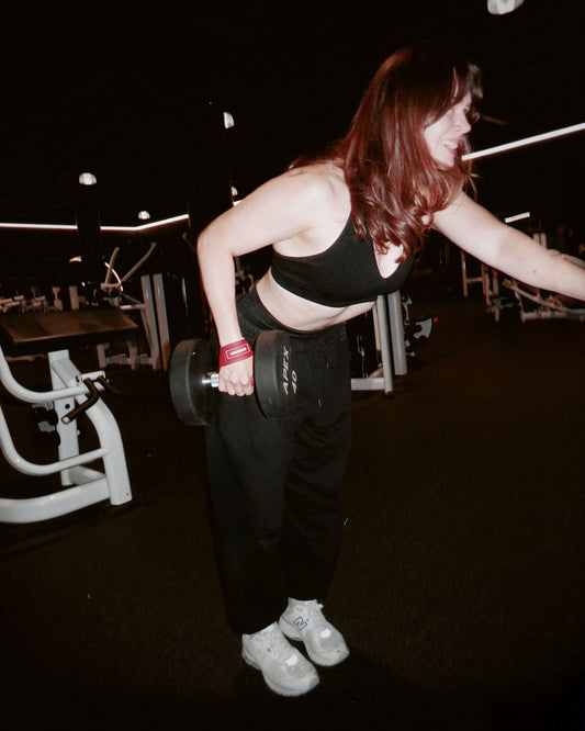 woman strength training with uppper lifting gear