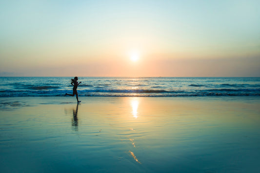 person jogging by beach